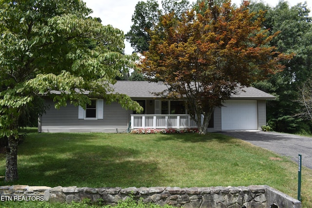 view of front of house with a garage, a front lawn, and a porch