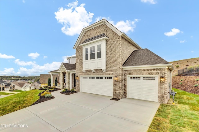 view of front of home featuring a front lawn and a garage