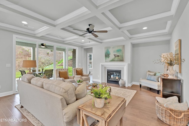 living room with light hardwood / wood-style flooring, beam ceiling, and coffered ceiling