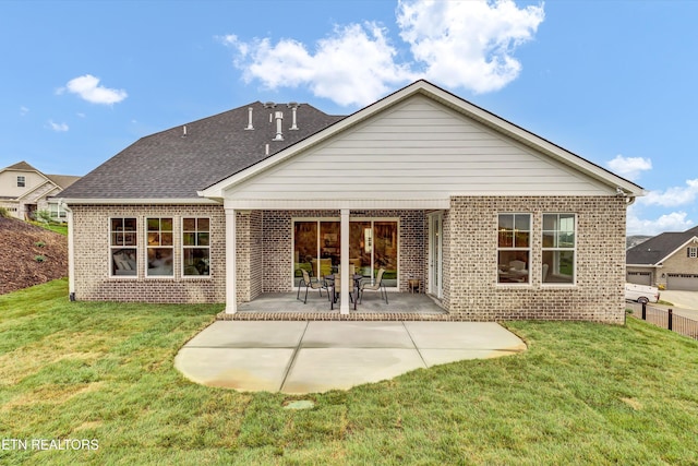 back of house featuring a patio and a lawn