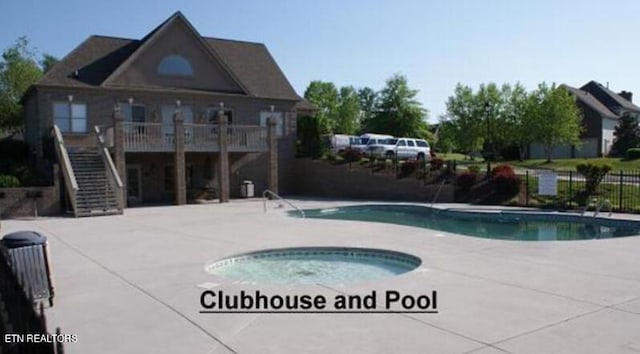 view of pool with a hot tub and a patio