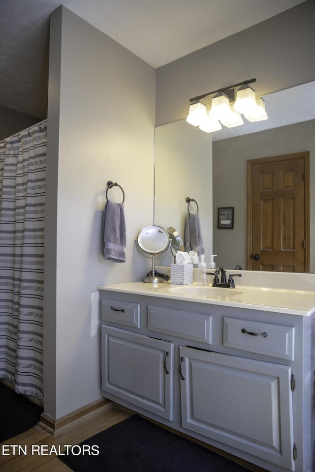 bathroom with vanity and wood-type flooring