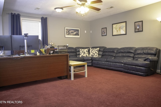 living room featuring ceiling fan, carpet floors, and a textured ceiling