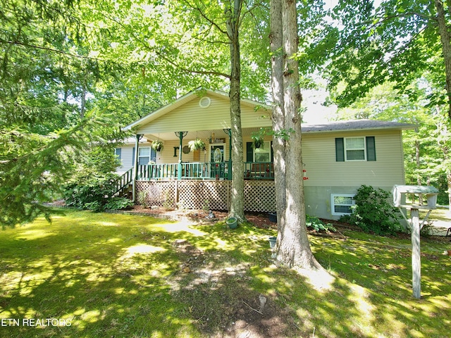 view of front of property with a porch and a front yard