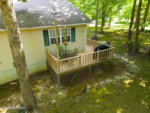 wooden deck with a lawn