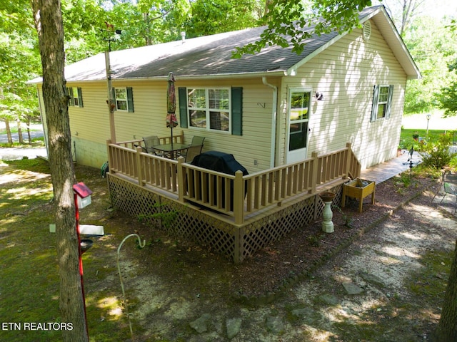 back of house featuring a wooden deck