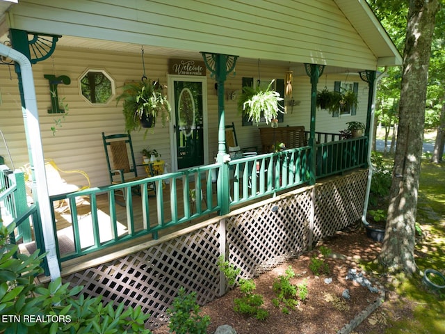 view of exterior entry featuring a porch