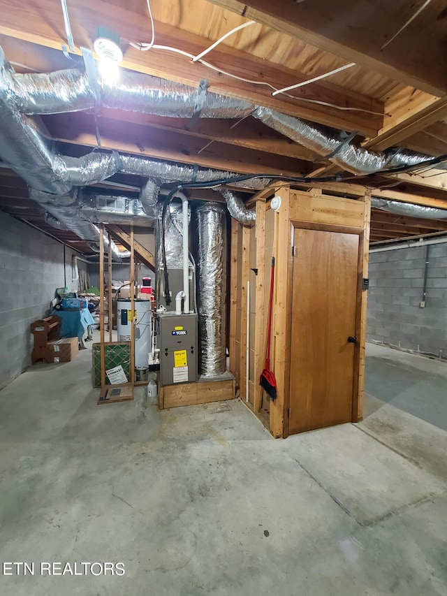 basement with heating unit and electric water heater