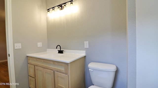 bathroom featuring toilet and vanity