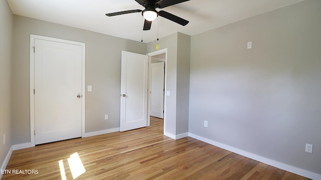 unfurnished bedroom with ceiling fan and light hardwood / wood-style floors