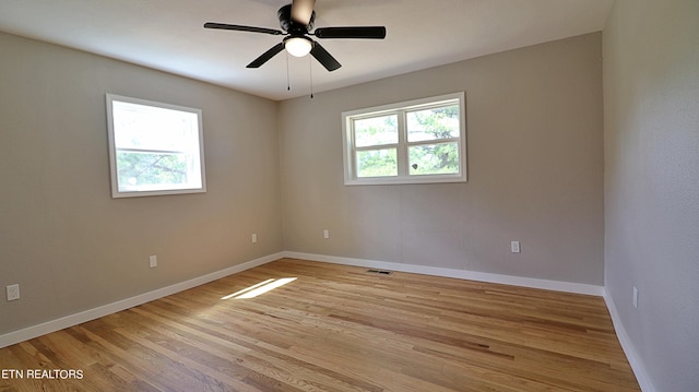 spare room with ceiling fan and light wood-type flooring