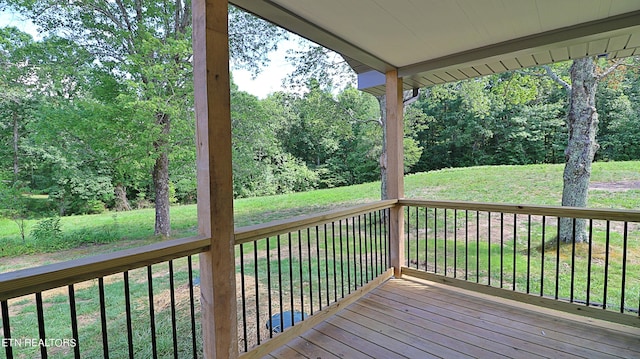 wooden terrace with a yard