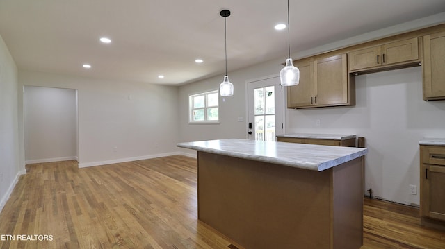 kitchen featuring wood-type flooring, a center island, and pendant lighting