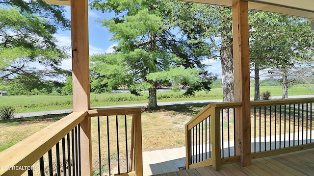 wooden terrace featuring a lawn