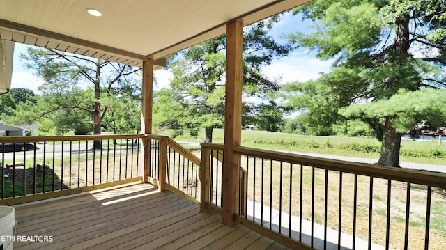 wooden terrace featuring a yard