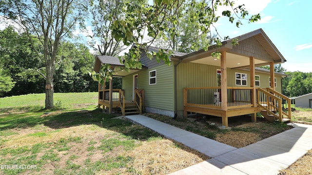 exterior space featuring a front lawn and covered porch