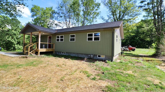 rear view of property with a lawn