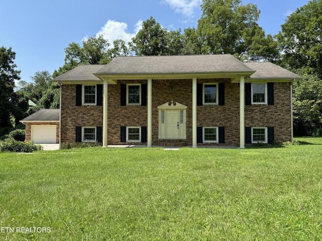 bi-level home with a garage and a front lawn