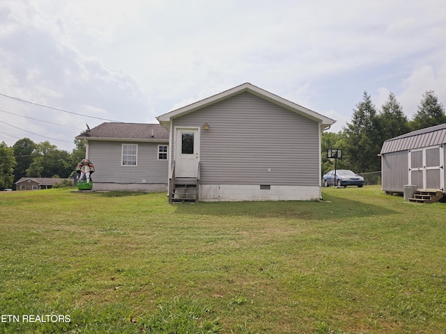 rear view of house featuring a lawn