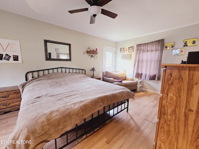 bedroom with ceiling fan and light hardwood / wood-style floors