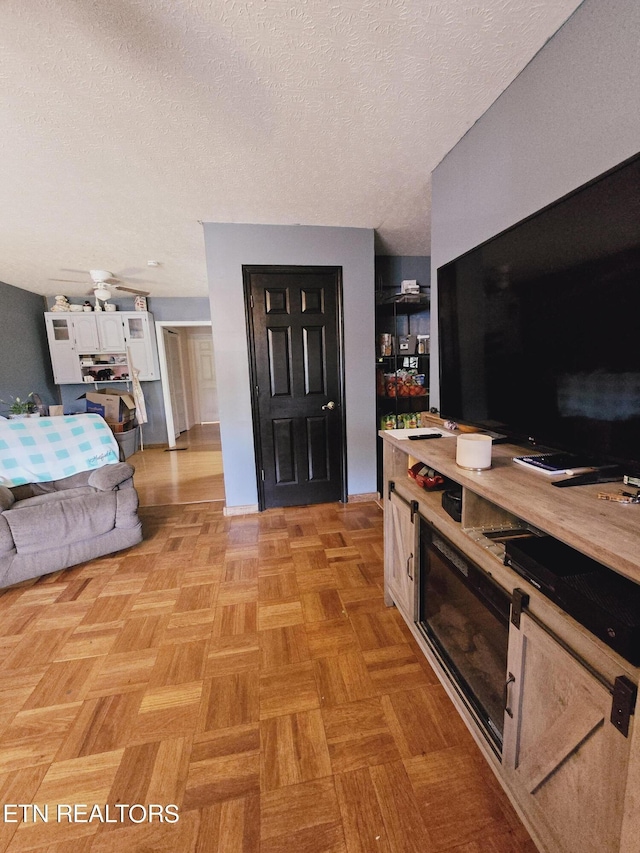 living room featuring light parquet flooring and a textured ceiling