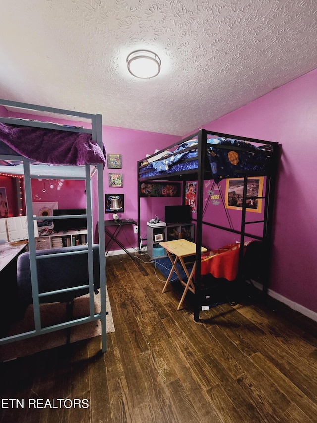 bedroom featuring a textured ceiling and hardwood / wood-style flooring