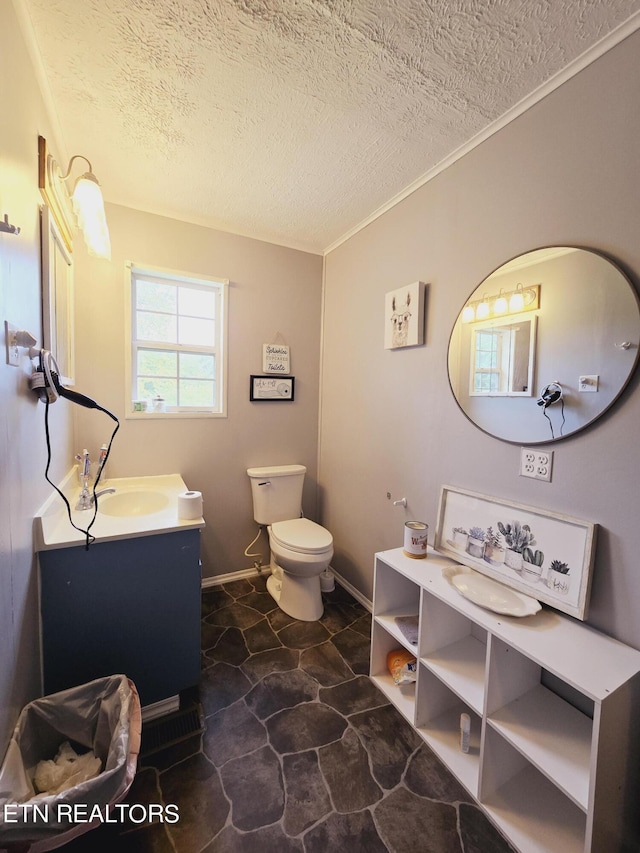 bathroom with a textured ceiling, toilet, and vanity