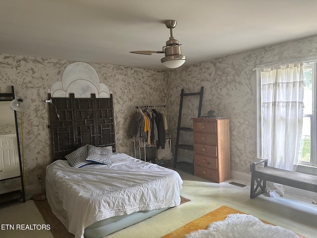 bedroom featuring ceiling fan and multiple windows