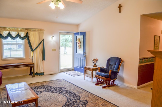 interior space featuring carpet flooring, ceiling fan, and vaulted ceiling