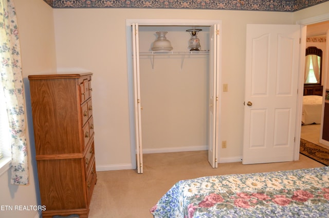 carpeted bedroom with a closet