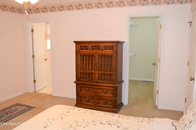 carpeted bedroom with a spacious closet