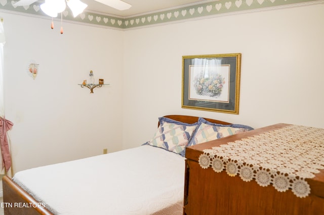 bedroom with ceiling fan and ornamental molding