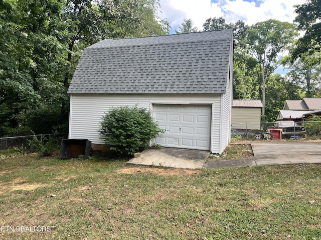 garage featuring a lawn