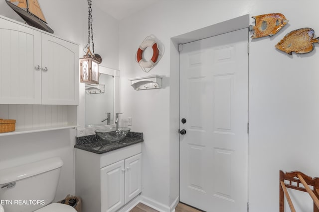 bathroom featuring toilet and vanity