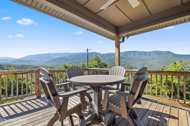 deck featuring ceiling fan and a mountain view