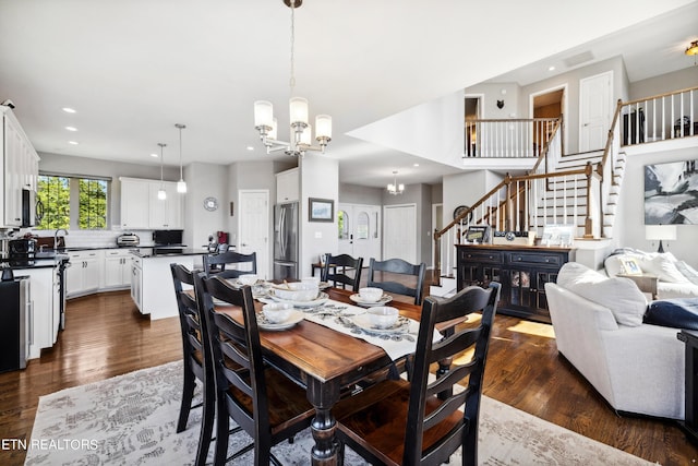 dining room with dark wood-type flooring, a chandelier, and sink