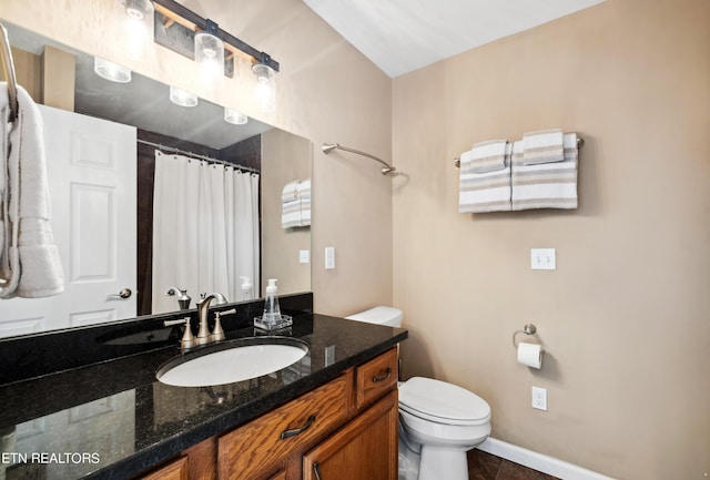 bathroom with toilet, vanity, tile patterned floors, and curtained shower