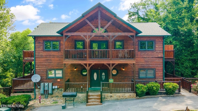 view of front facade with a balcony and a porch