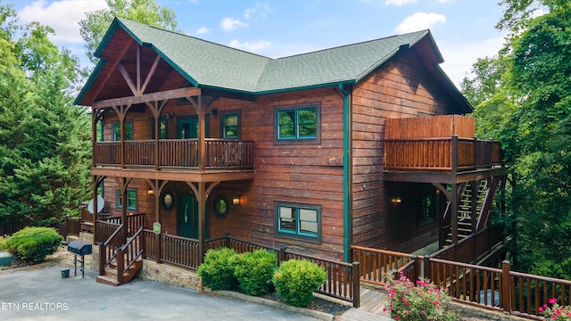 cabin featuring a porch and a balcony