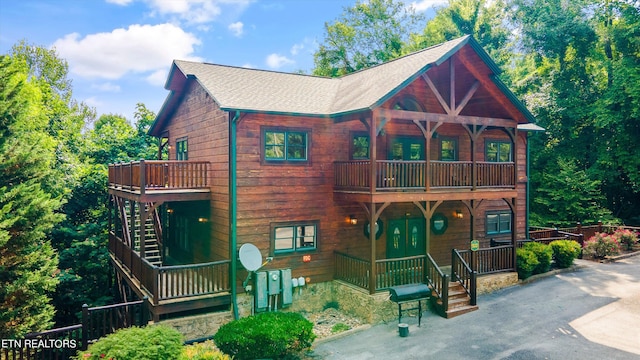 cabin featuring covered porch and a balcony