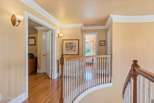 hallway featuring wood-type flooring and ornamental molding