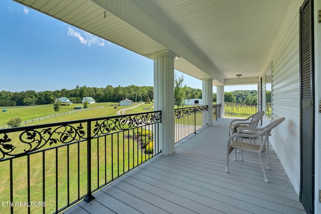 wooden terrace with a yard