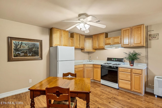 kitchen featuring light hardwood / wood-style flooring, ceiling fan, light brown cabinets, and white appliances