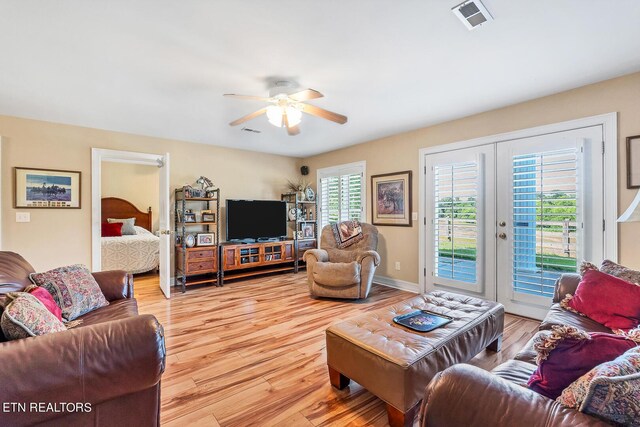 living room featuring light hardwood / wood-style floors, french doors, and ceiling fan