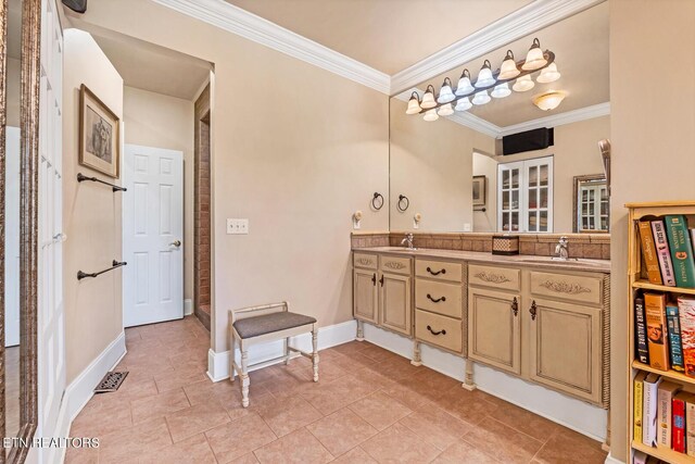 bathroom with tile patterned flooring, double vanity, and ornamental molding