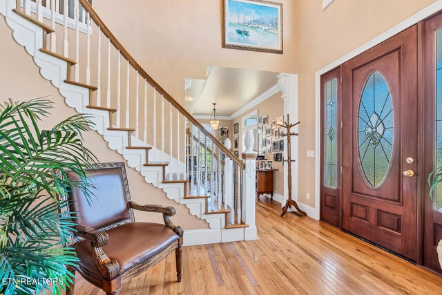 entryway featuring light hardwood / wood-style flooring and ornamental molding