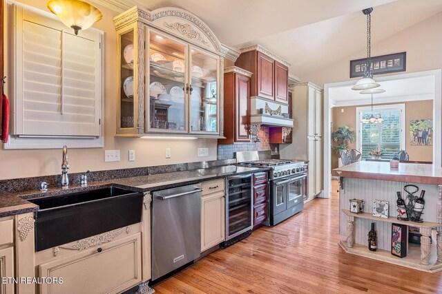 kitchen with appliances with stainless steel finishes, sink, light hardwood / wood-style floors, custom exhaust hood, and beverage cooler