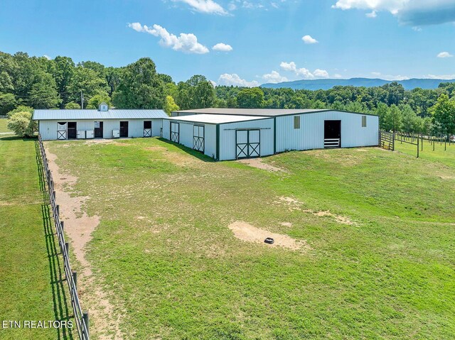 manufactured / mobile home featuring an outbuilding, a front lawn, and a rural view