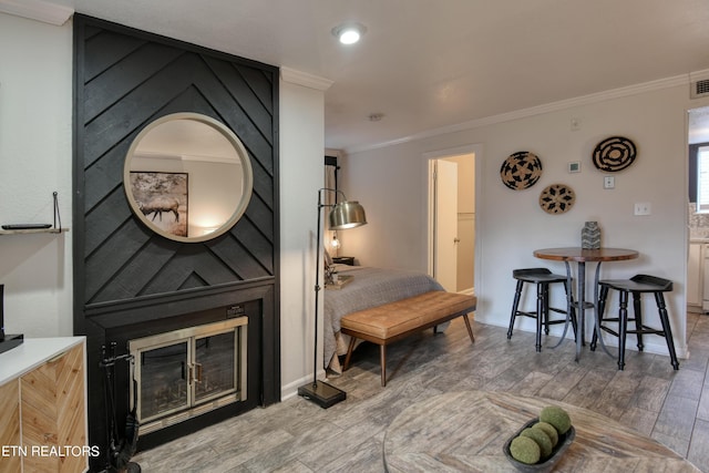 living room with a large fireplace and ornamental molding