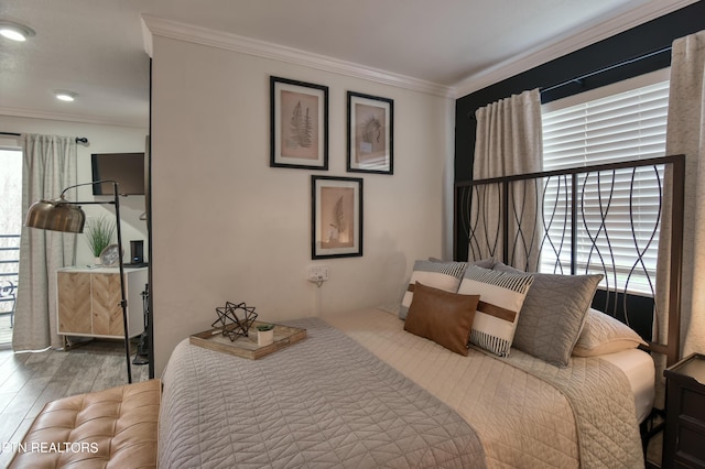 bedroom featuring hardwood / wood-style flooring and ornamental molding